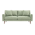 **Canapé moderne en tissu vert avec coussins, design épuré et pieds en bois**